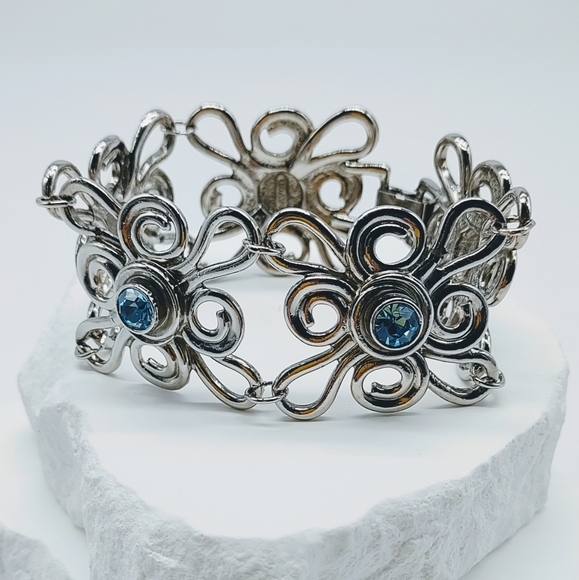 Avon Jewelry - Vintage Avon Silver Tone Blue Rhinestone Bold Flower Bracelet
